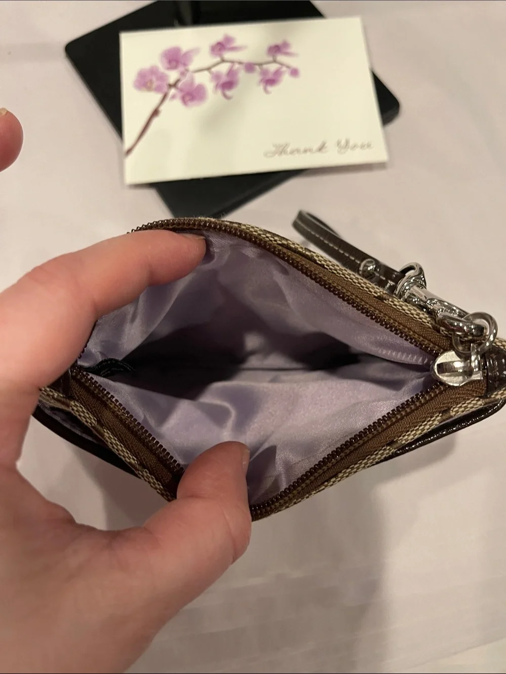 Coach Signature Small Wristlet in a khaki zipped coin purse